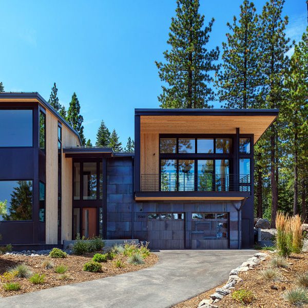 Large house with cedar siding, soffit, and black siding.