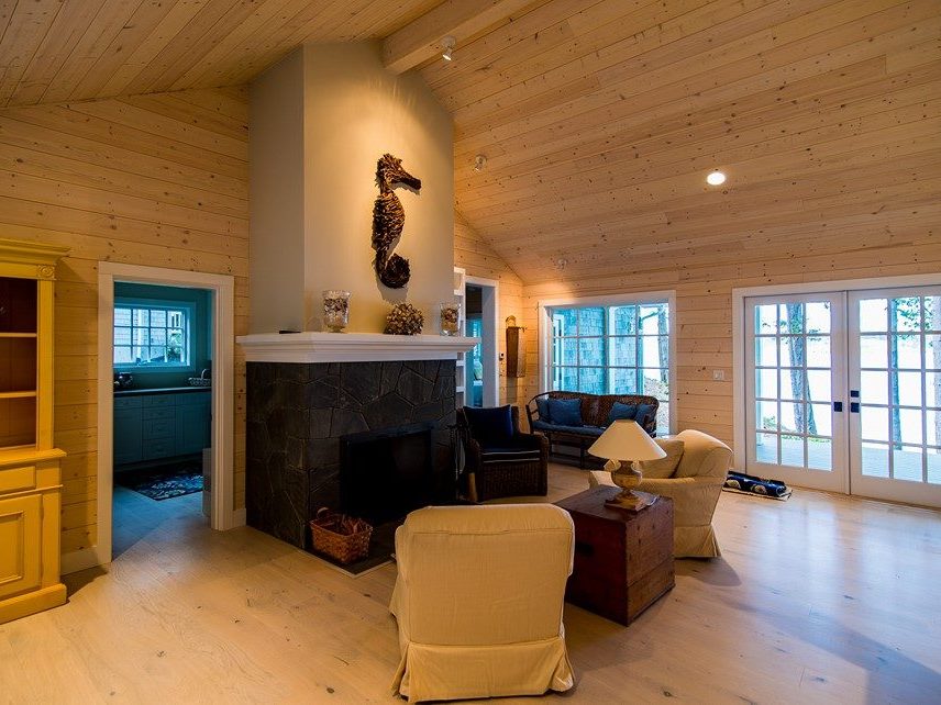 Pine paneling on the ceiling and walls of a large sitting room
