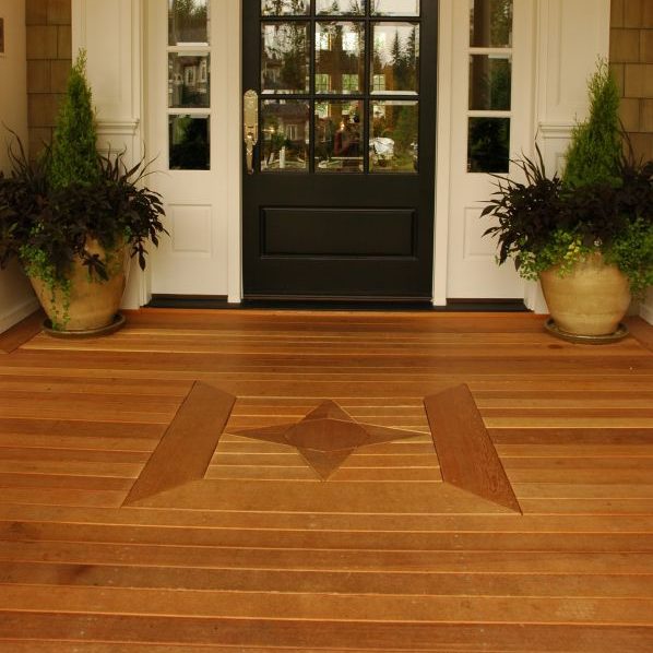 Cedar porch with a nautical star inset in front of the entrance.