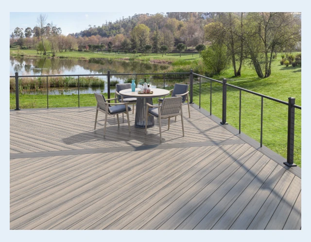 Deckorators Voyage Decking in Costa with Sierra picture framing and ALX Contemporary cable rail A gray deck built with Deckorators Voyage decking in Costa with Sierra picture framing and a black aluminum cable railing around the edge.