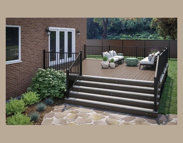 Deckorators Voyage Decking in Khaya with a Tundra Border and Aluminum Rapid Rail in Weathered Brown. An image in front of 5 stairs that lead to a deck built with Deckorators Voyage decking in Khaya, surrounded by an aluminum baluster rail.