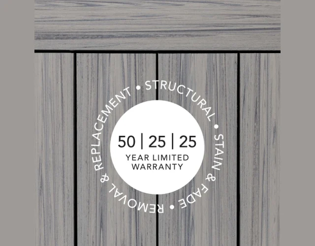 Deckorators Voyage decking made with Surestone technology is backed by a 50-year Structural, 25-year Stain & Fade, and 25-year Removal & Replacement warranty. A circle overlay on top of Deckorators Voyage decking in Tundra that shows the warranty coverage of Voyage Decking